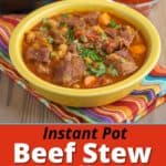 A bowl of Spanish beef stew in front of a dish of smoked spanish paprika - pimenton de la Vera - and an Instant Pot