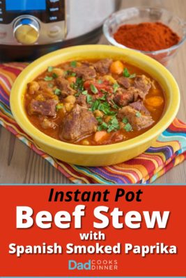 A bowl of Spanish beef stew in front of a dish of smoked spanish paprika - pimenton de la Vera - and an Instant Pot