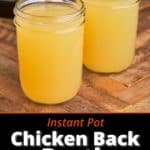 Two jars of chicken broth on a wood table in front of an Instant Pot