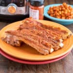 Spanish ribs on a yellow plate with smoked paprika, chickpeas, and an Instant Pot in the backgroud