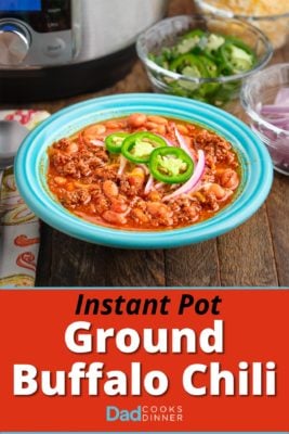 A bowl of ground buffalo chili, with an Instant Pot and sliced toppings in the background