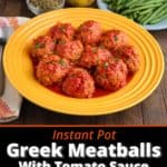A plate of Greek meatballs in tomato sauce, with green beans, lemons, oregano, and rice in the background