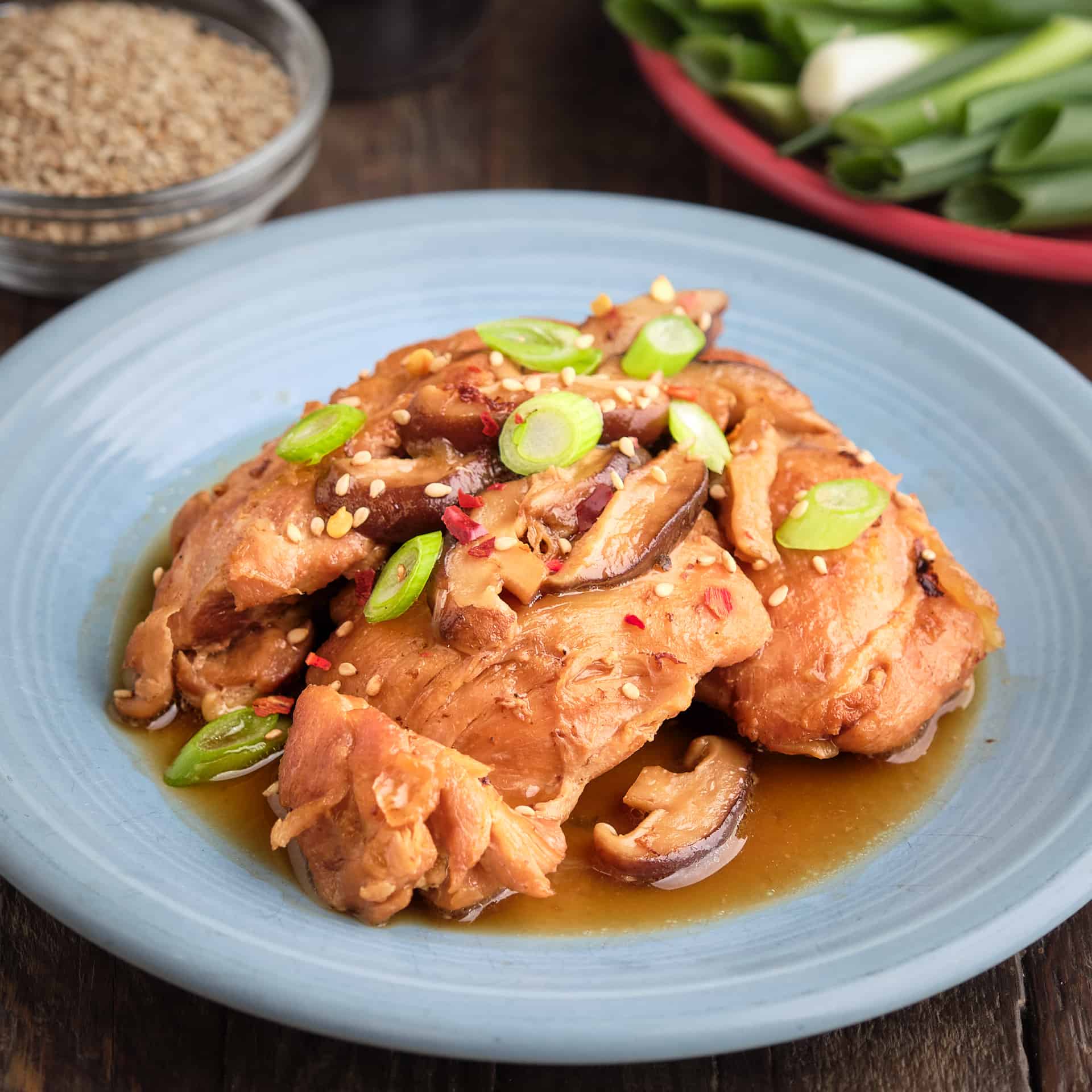 A plate of Chicken with Shiitake mushrooms, Sesame seeds and green onions