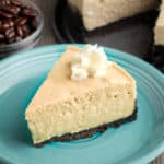 A slice of espresso cheesecake topped with whipped cream