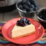 A slice of goat cheese cheesecake topped with blueberries