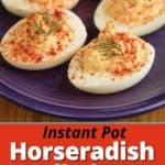 A plate of horseradish deviled eggs sprinkled with paprika and topped with a sprig of dill