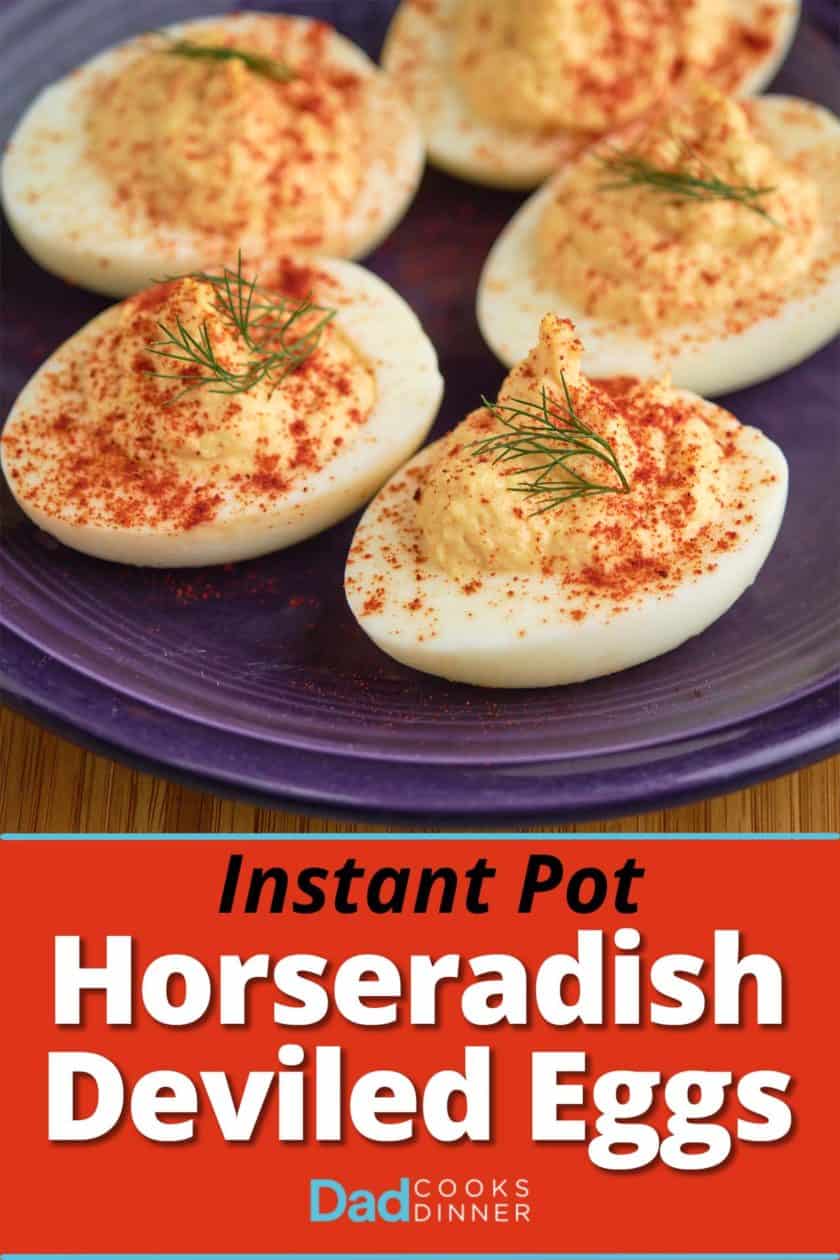 A plate of horseradish deviled eggs sprinkled with paprika and topped with a sprig of dill