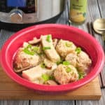 A bowl of sumo soup, with meatballs, tofu, mushrooms, and scallions, with an Instant Pot and Hot Yuzu Sauce in the background