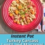 A bowl of turkey, lentil, and macaroni soup, made from the bones of a roasted turkey carcass, with a spoon, napkin, red pepper flakes, and Instant Pot in the background