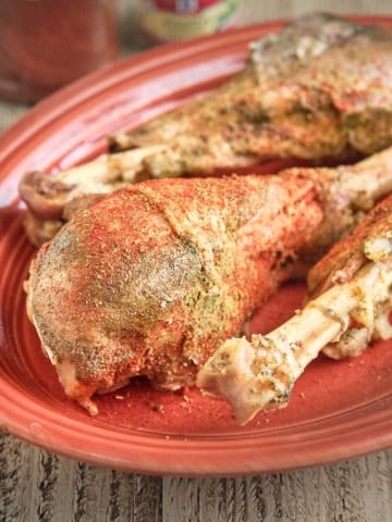 Turkey legs, sprinkled with spices, on a platter