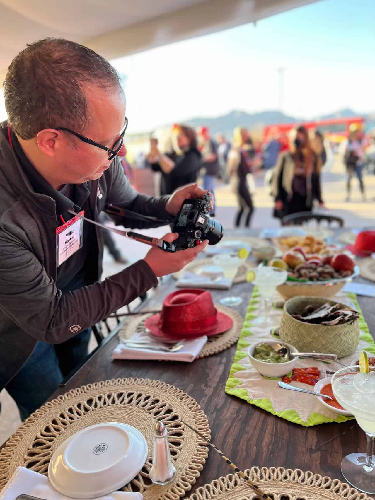 Mike Vrobel, camera in hand, over a Mexican table - courtesy of @bethsips