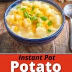 A bow of potato soup topped with shredded cheddar and sliced green onion, on a wooden table with an Instant Pot in the background.