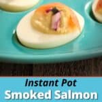 A smoked salmon deviled egg on a teal egg plate