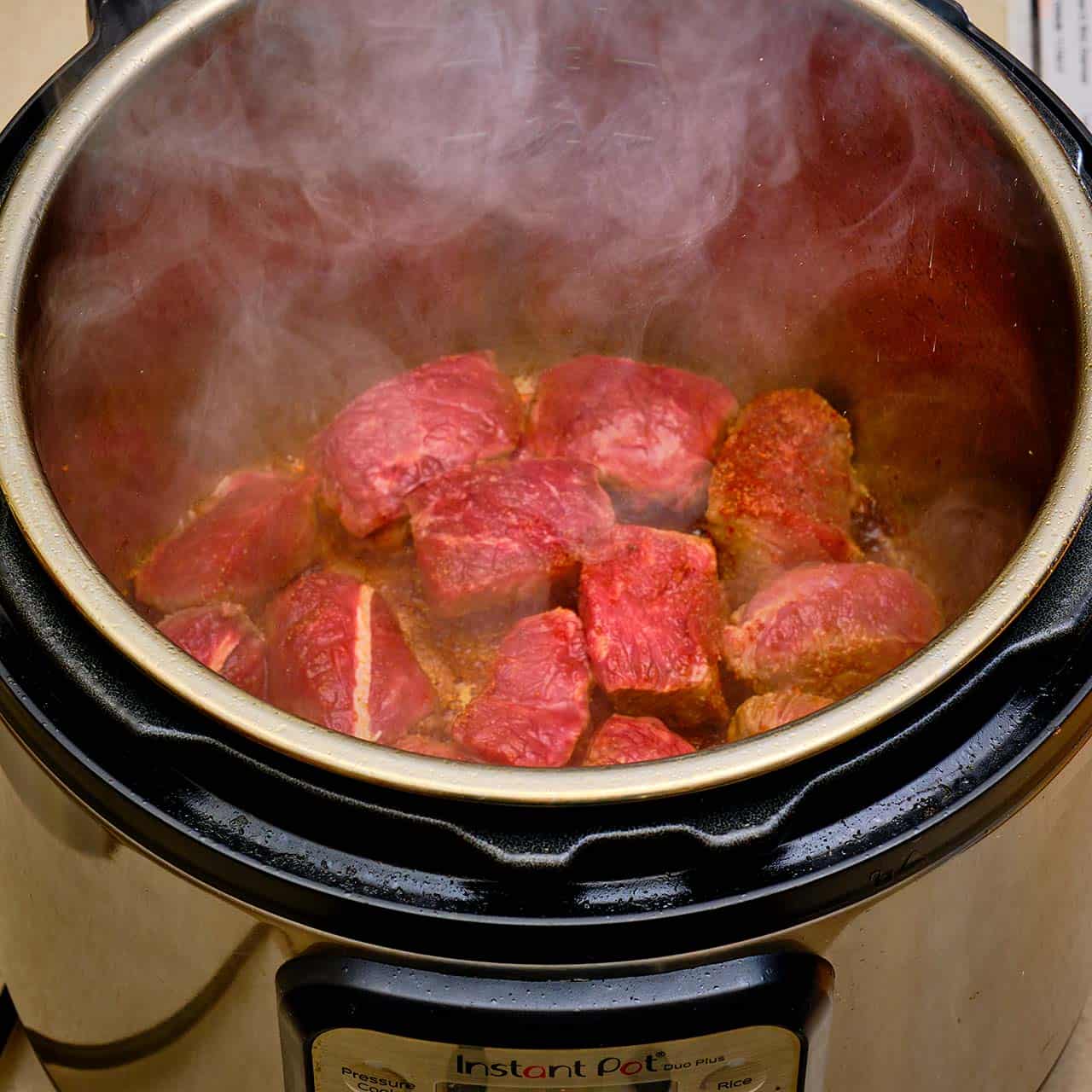 Beef cubes searing in an Instant Pot