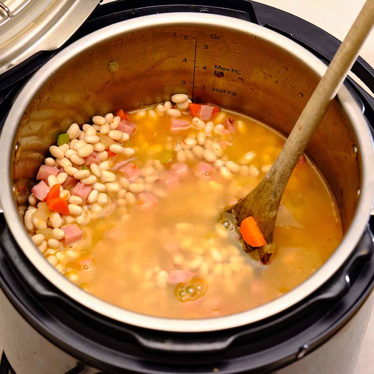 Navy beans, ham, carrots, celery, and chicken broth in an Instant Pot