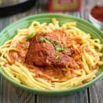 A bowl of chicken paprikash on noodles