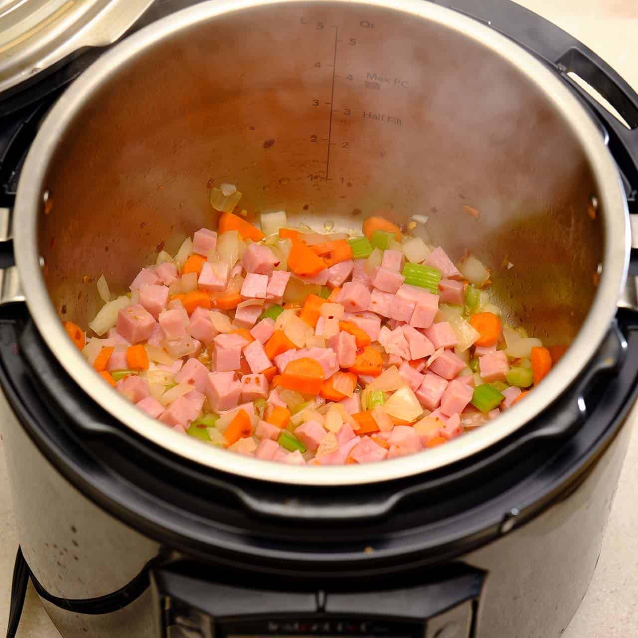 Ham, onions, carrots, and celery sauteing in an Instant Pot