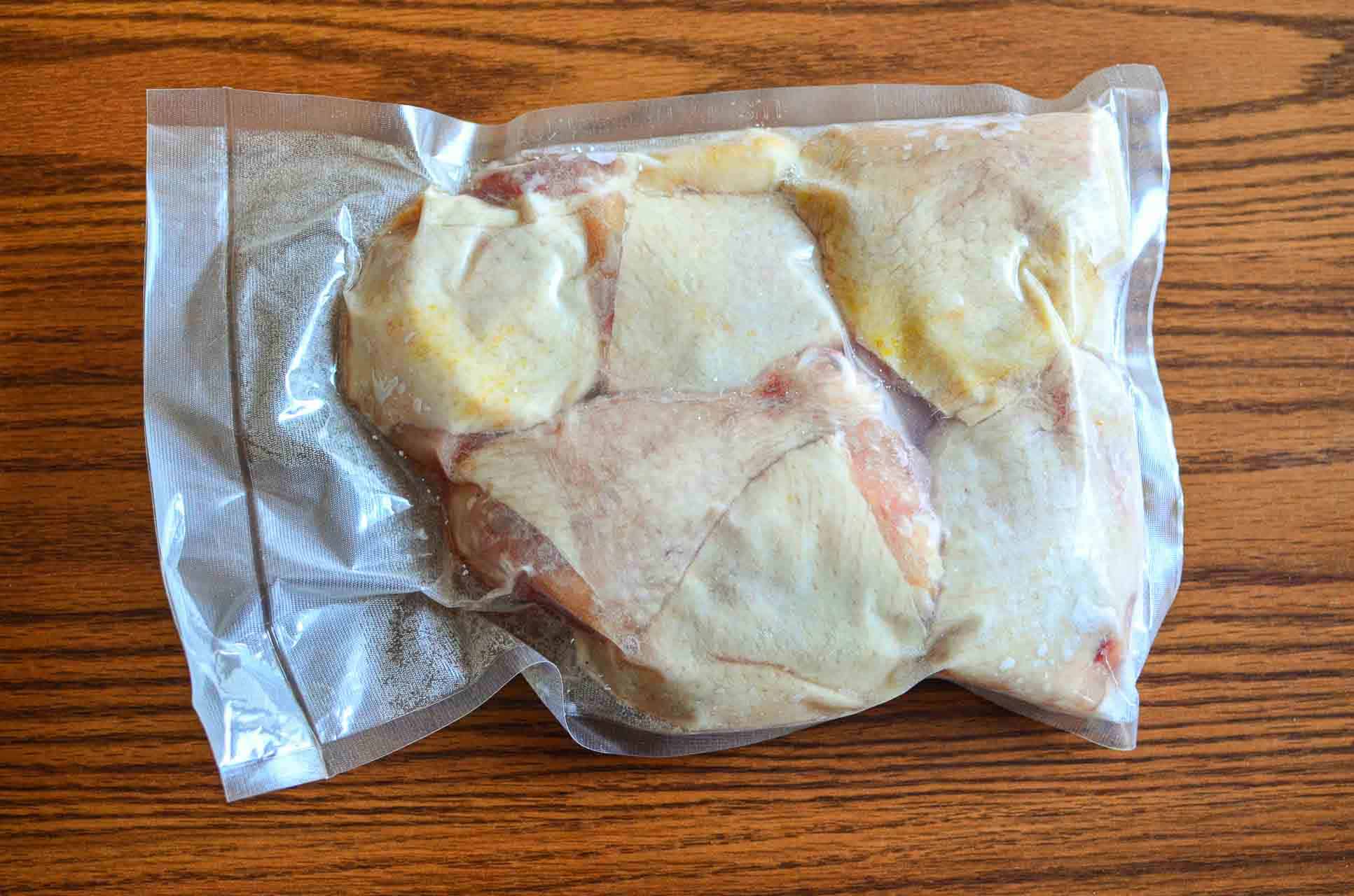 A vacuum sealed bag of chicken thighs