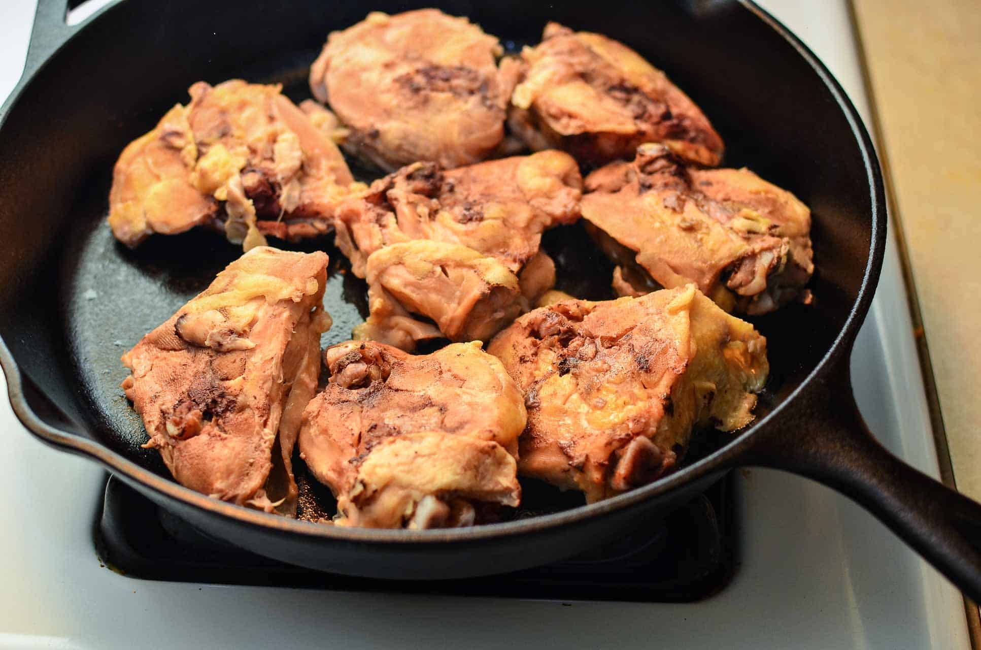 A cast iron pan full of chicken thighs