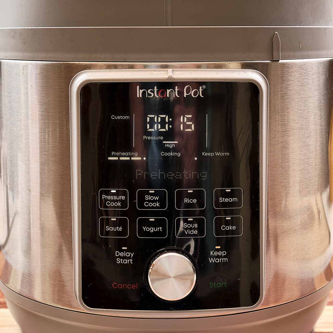 An instant pot set to pressure cook for 15 minutes on high