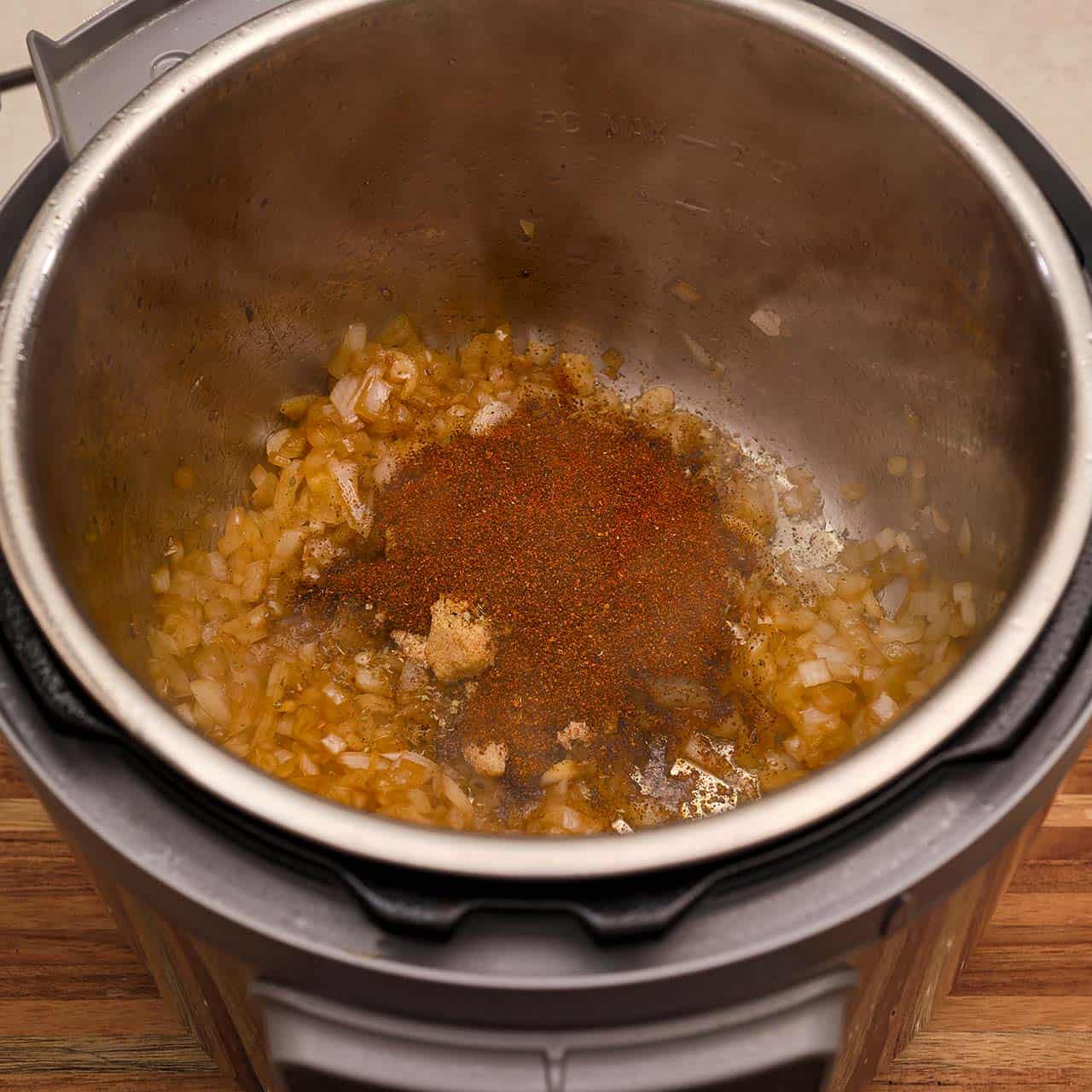 Onions and spices sautéing in an instant pot