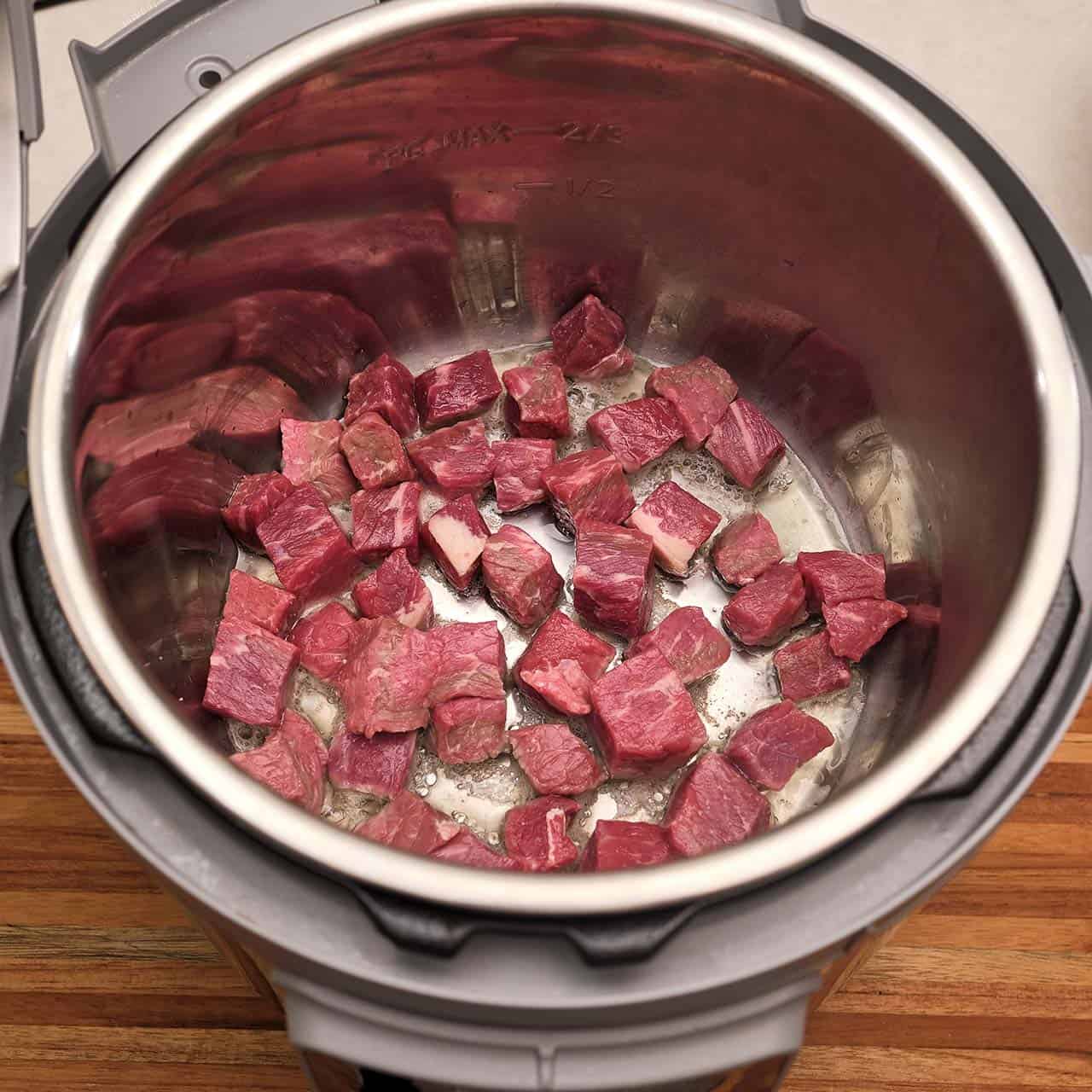 Beef cubes searing in an Instant Pot