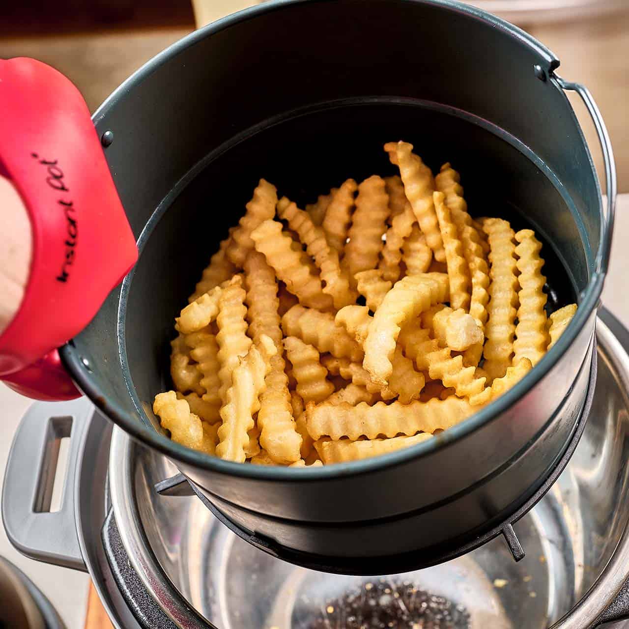 An Instant Pot Air Fryer Basket full of fries