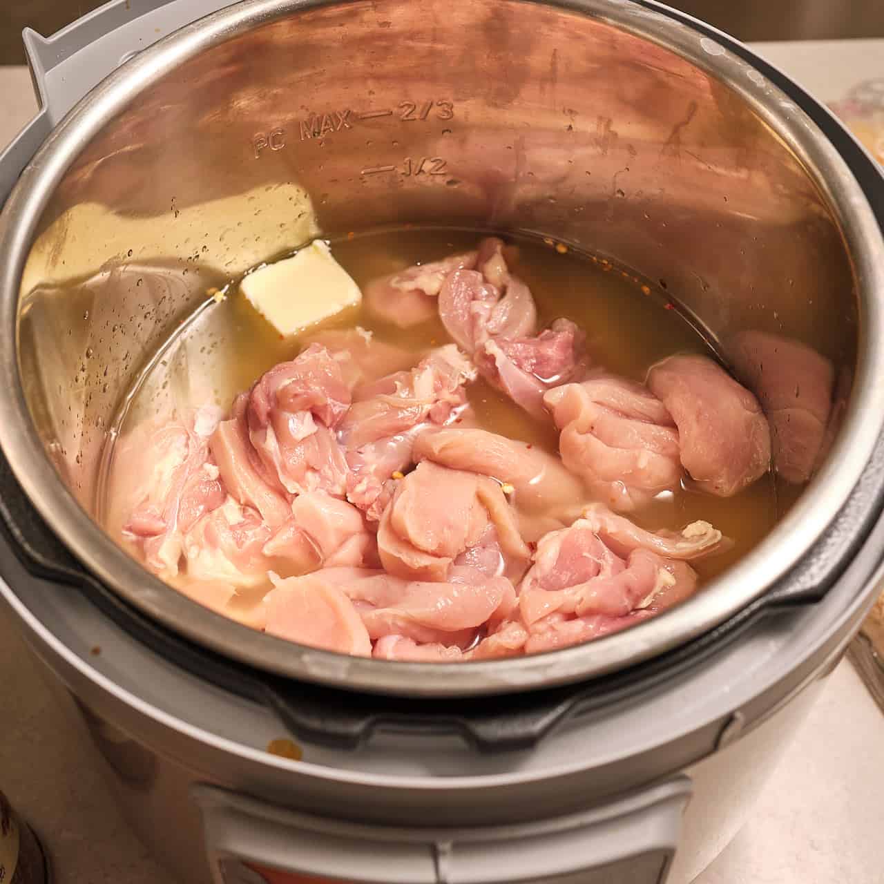 Chicken, broth, and butter over egg noodles in an Instant Pot