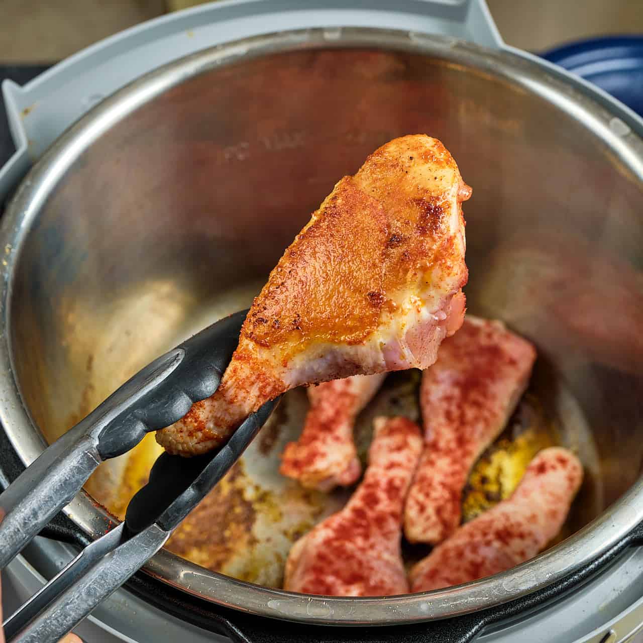 Browned chicken drumstick over an Instant Pot