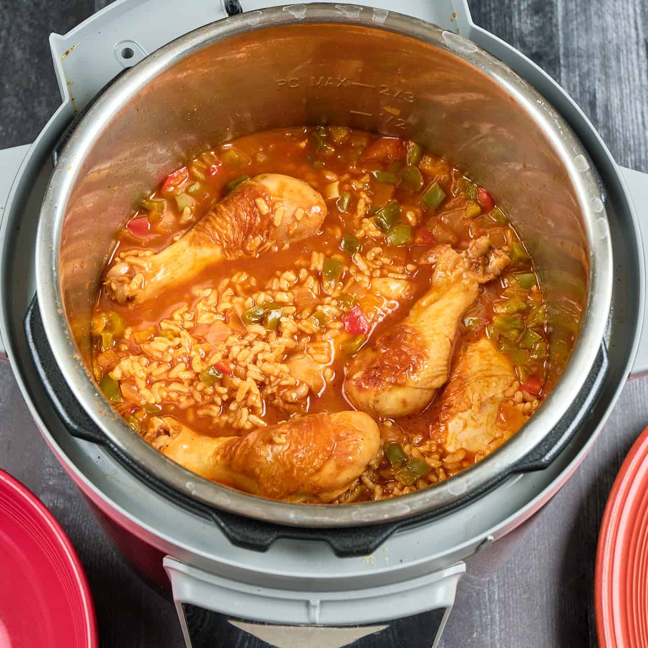An Instant Pot full of cooked chicken legs and rice