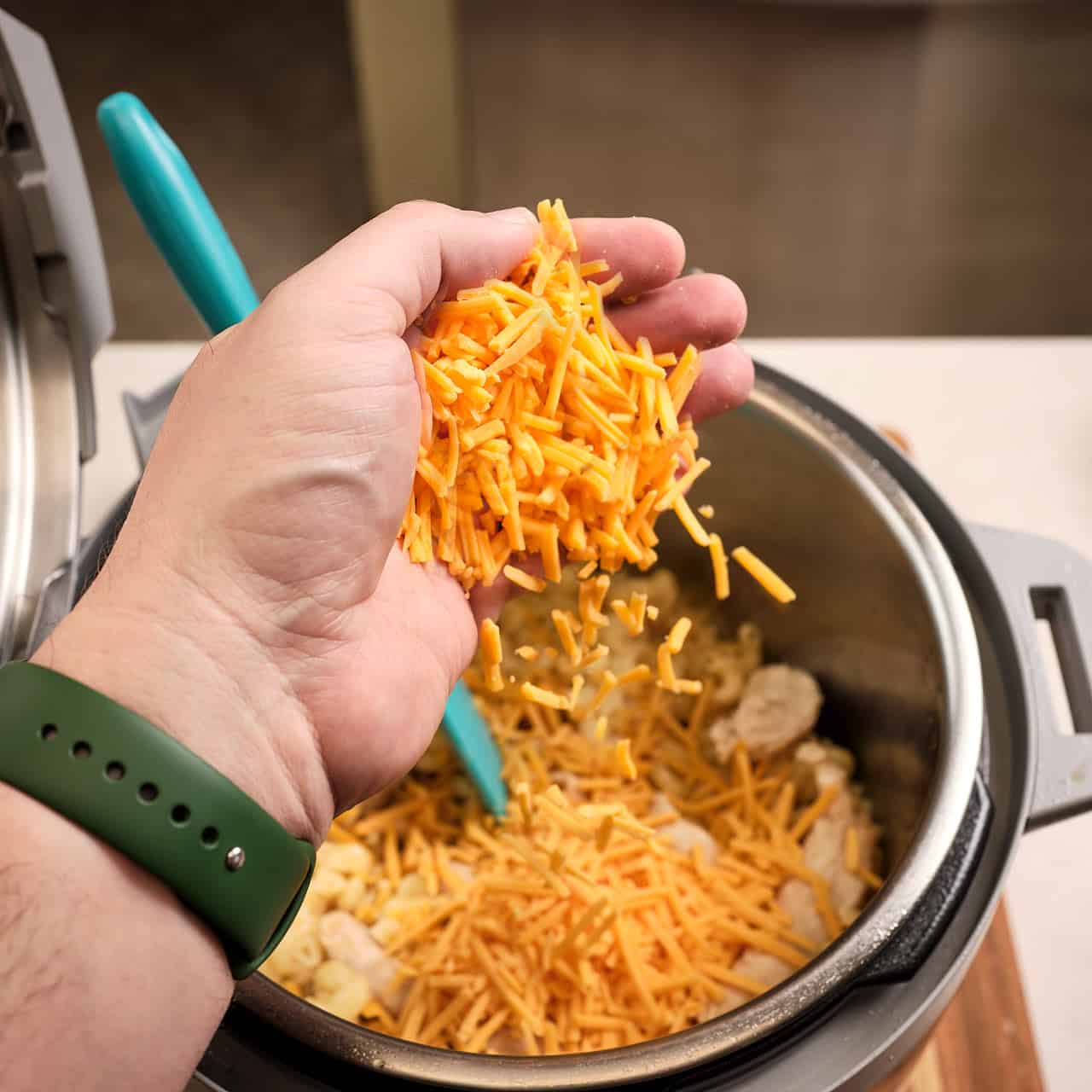 Sprinkling cheese into the pot