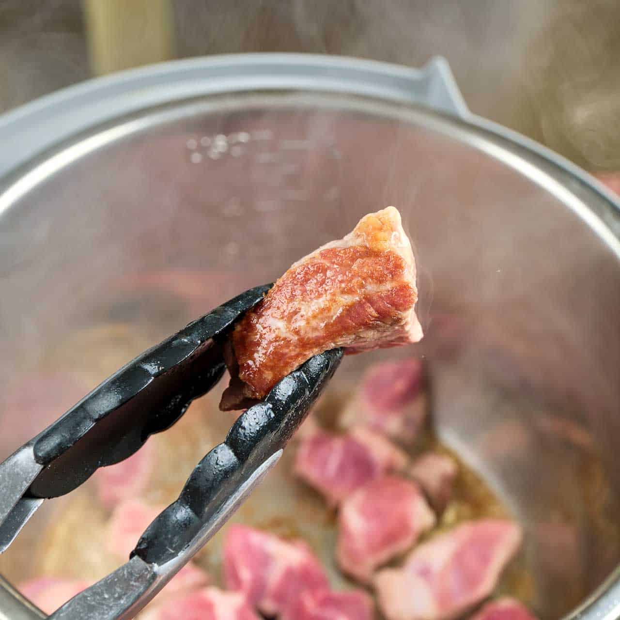 A browned piece of pork for Instant Pot Pork Adobo