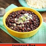 Bowl of Mexican black beans sprinkled with cheese and cilantro