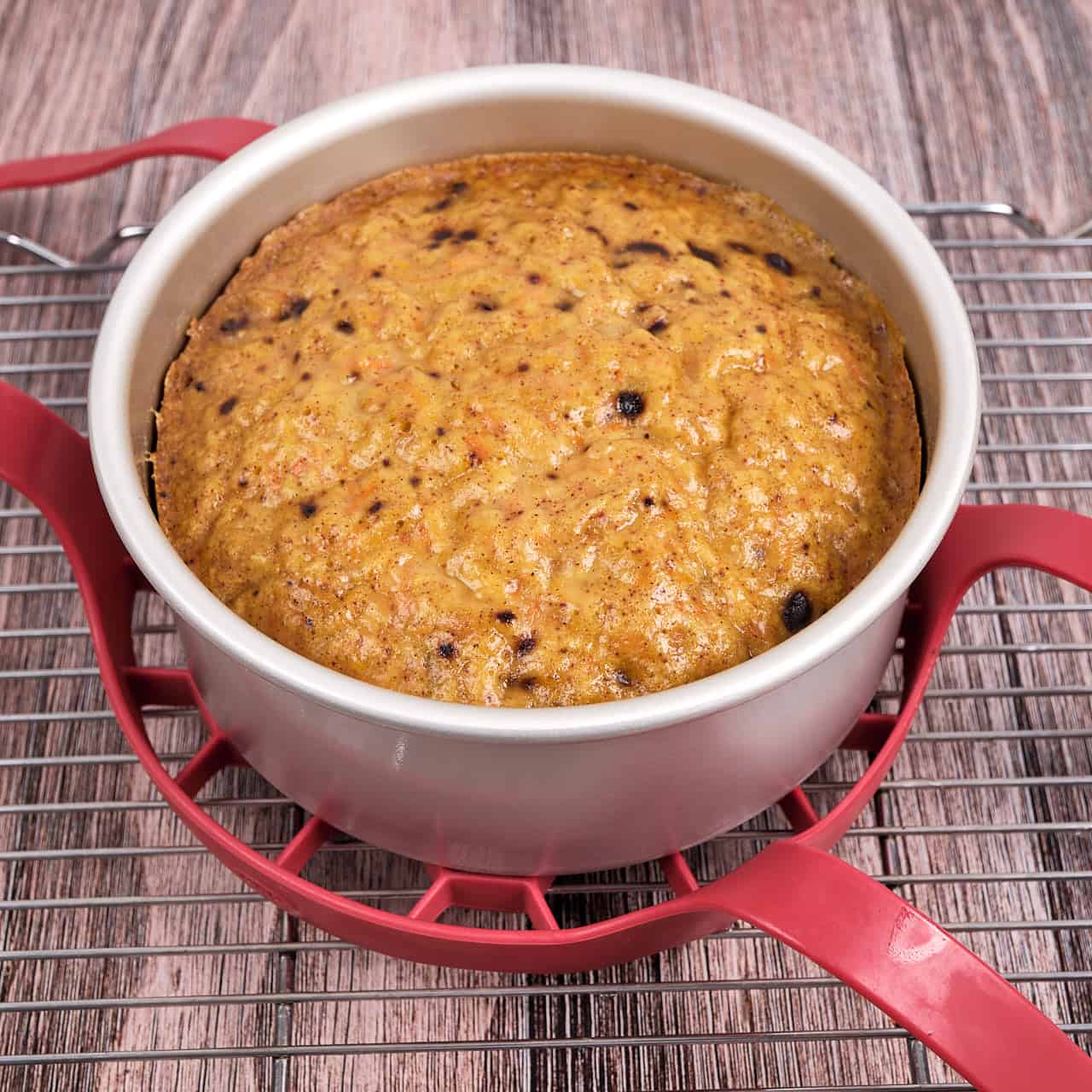 A carrot cake on a cooling rack