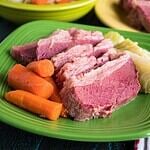 A plate of sliced corned beef with cabbage and carrots
