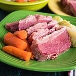 A plate of sliced corned beef with cabbage and carrots