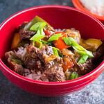 A bowl of Instant Pot Pepper Steak with chopsticks and rice