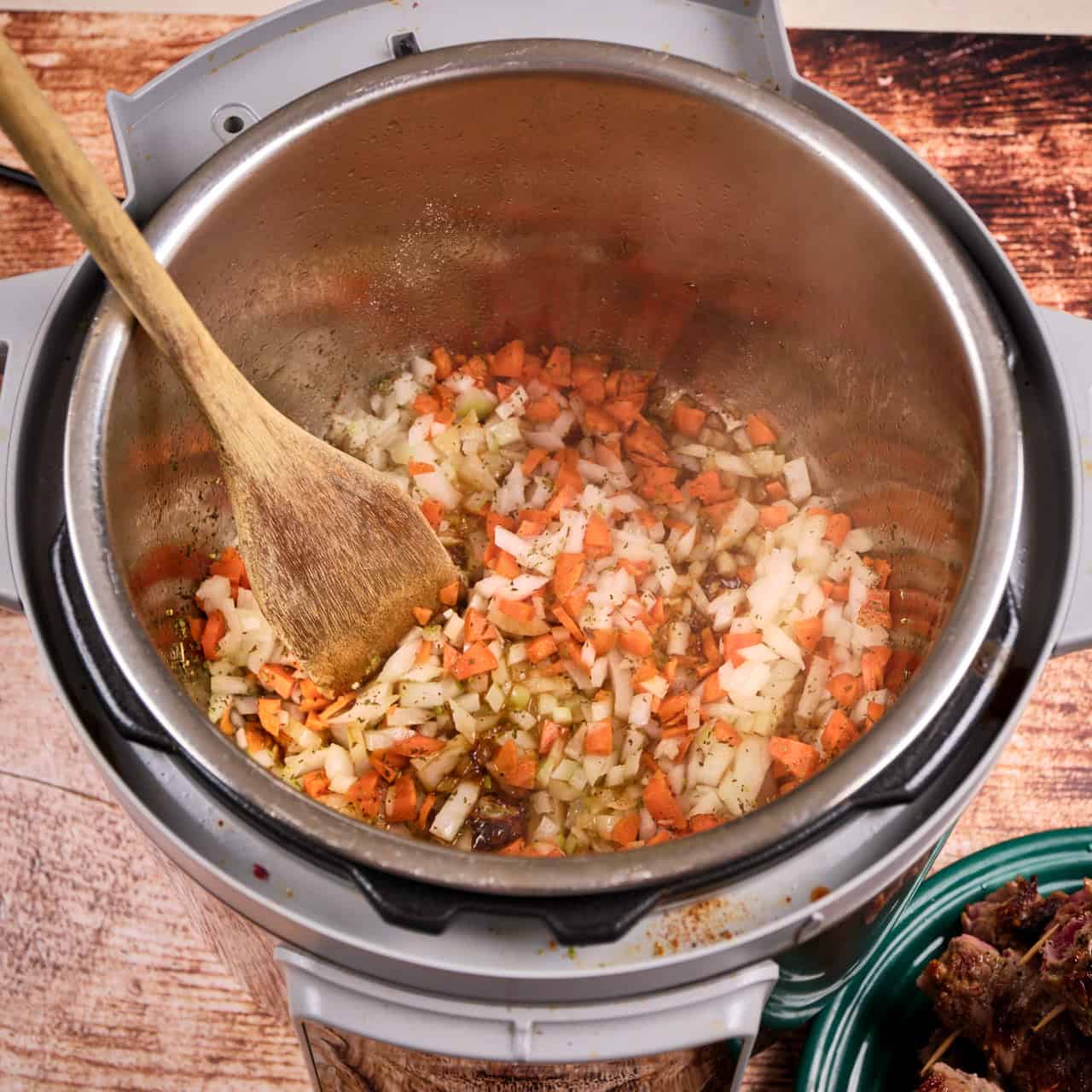 Onions, carrots, celery sautéing in an Instant Pot