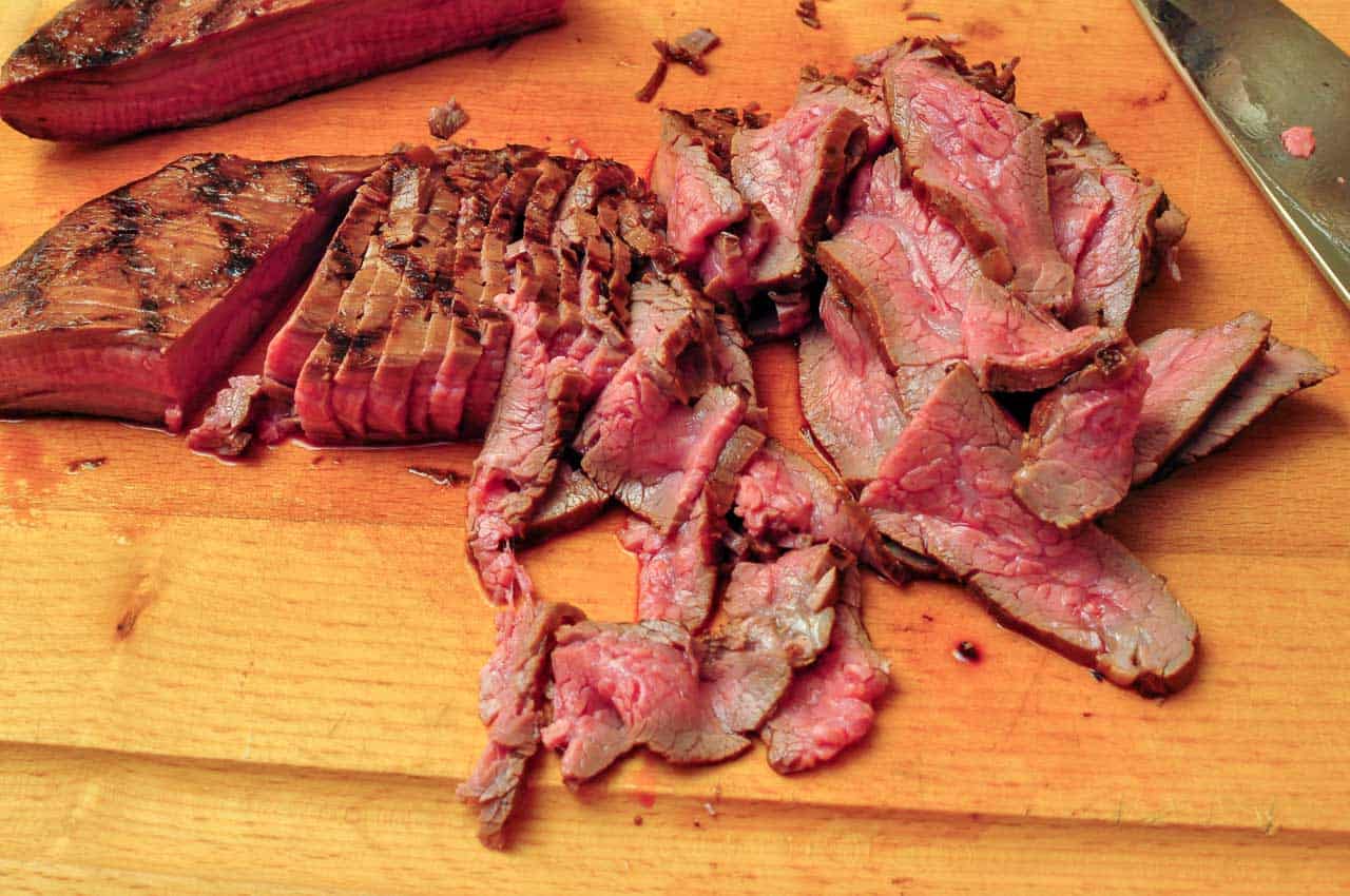 Slicing the grilled flank steak for fajitas