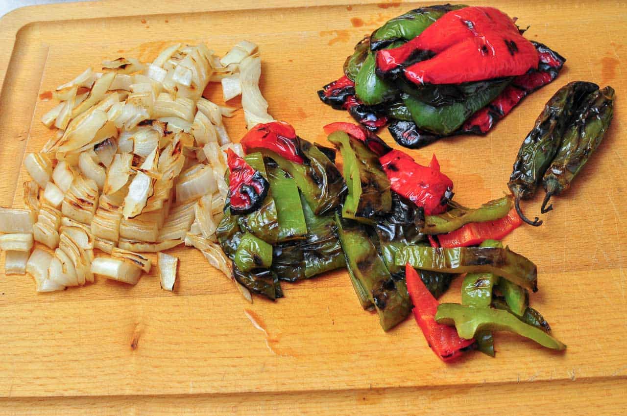 Slicing the grilled peppers and onions