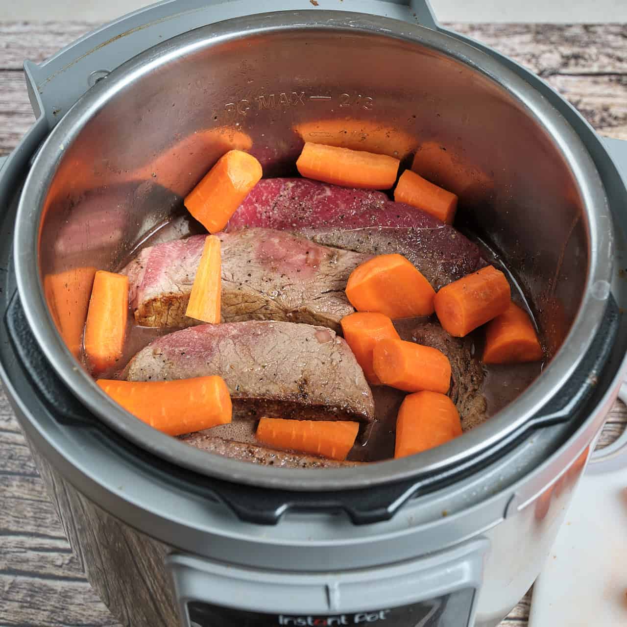 Instant pot full of sirloin tip roast and carrots