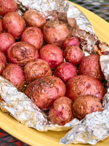 A platter of grilled baby potatoes in foil