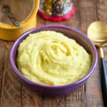 A bowl of Instant Pot mashed potatoes on a wood table