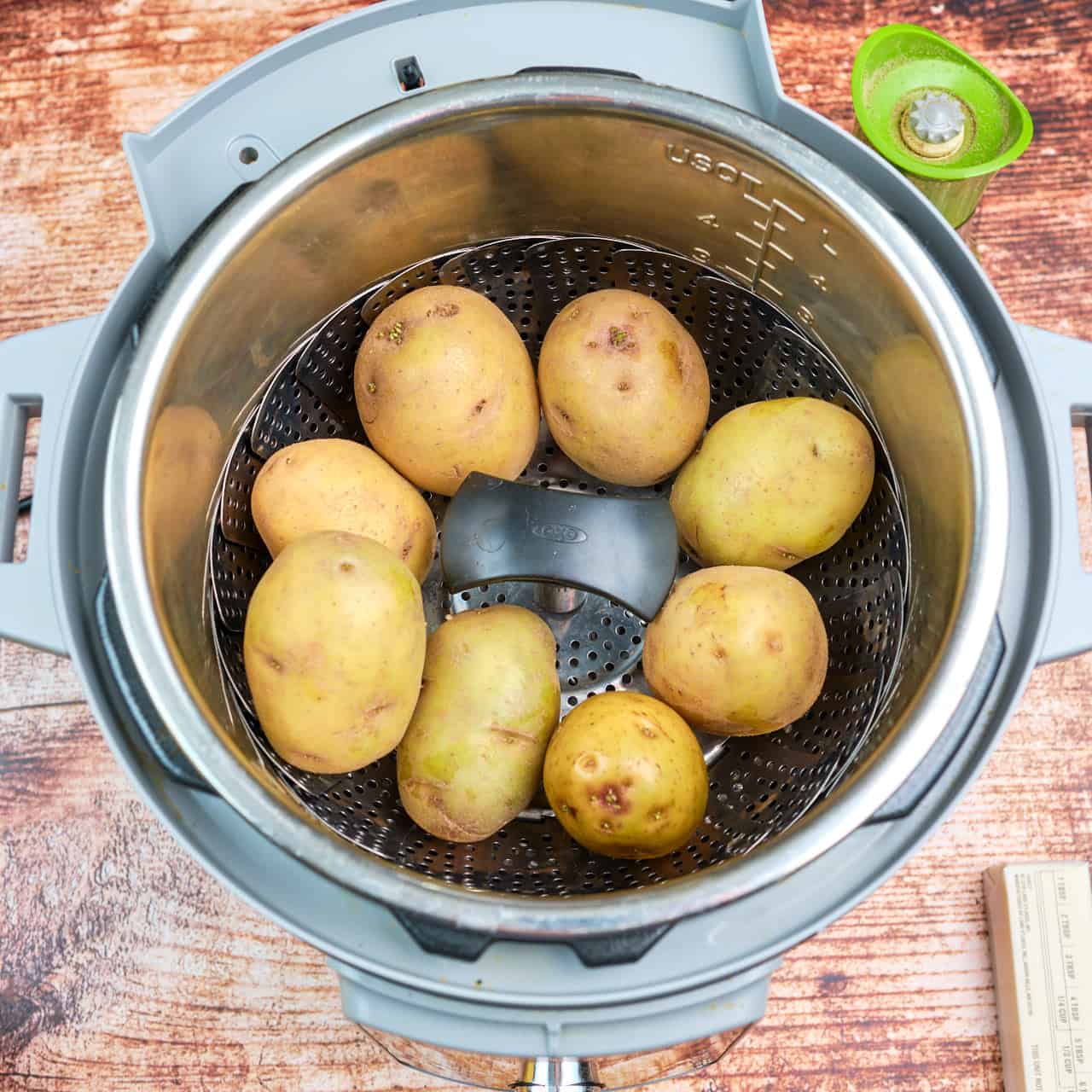 Potatoes in a vegetable steamer in an Instant Pot, ready to cook