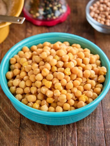 A bowl of Instant Pot Small Chickpeas (Ceci Piccoli) on a wood table