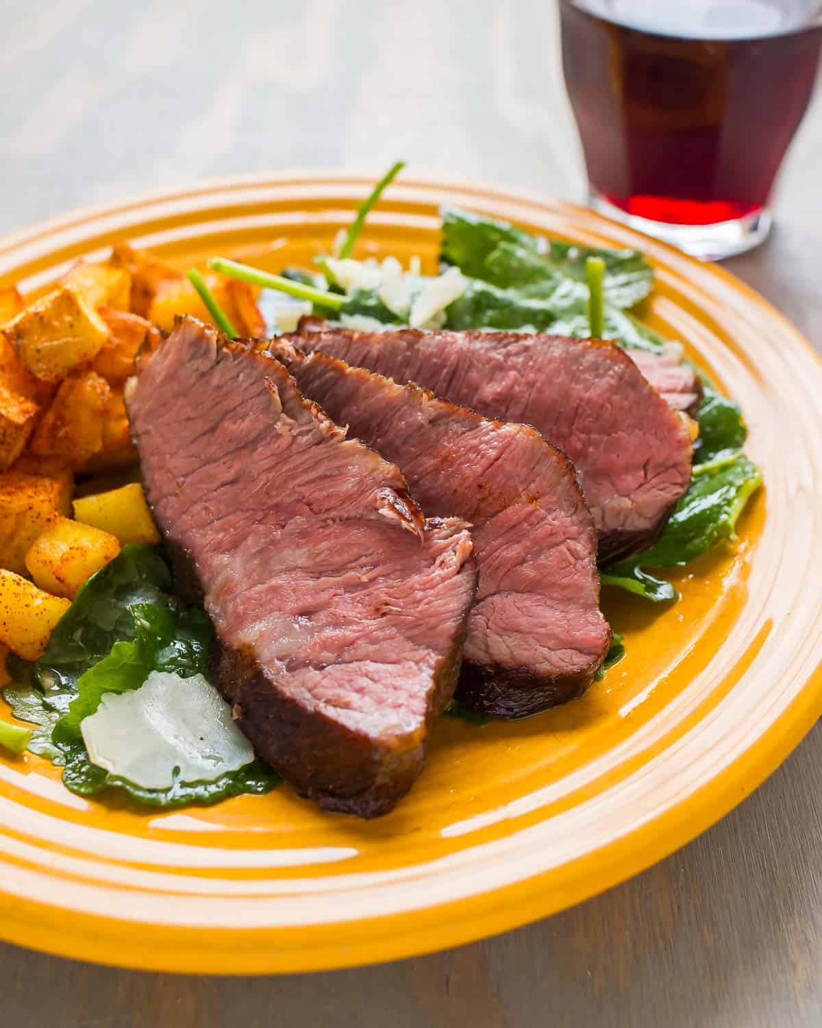 Sous Vide Flat Iron Steak on a bed of kale salad