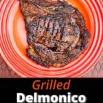 A grilled Delmonico steak on an orange plate