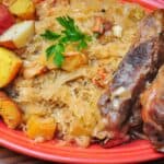 A platter of pork shoulder ribs, sauerkraut, and potatoes