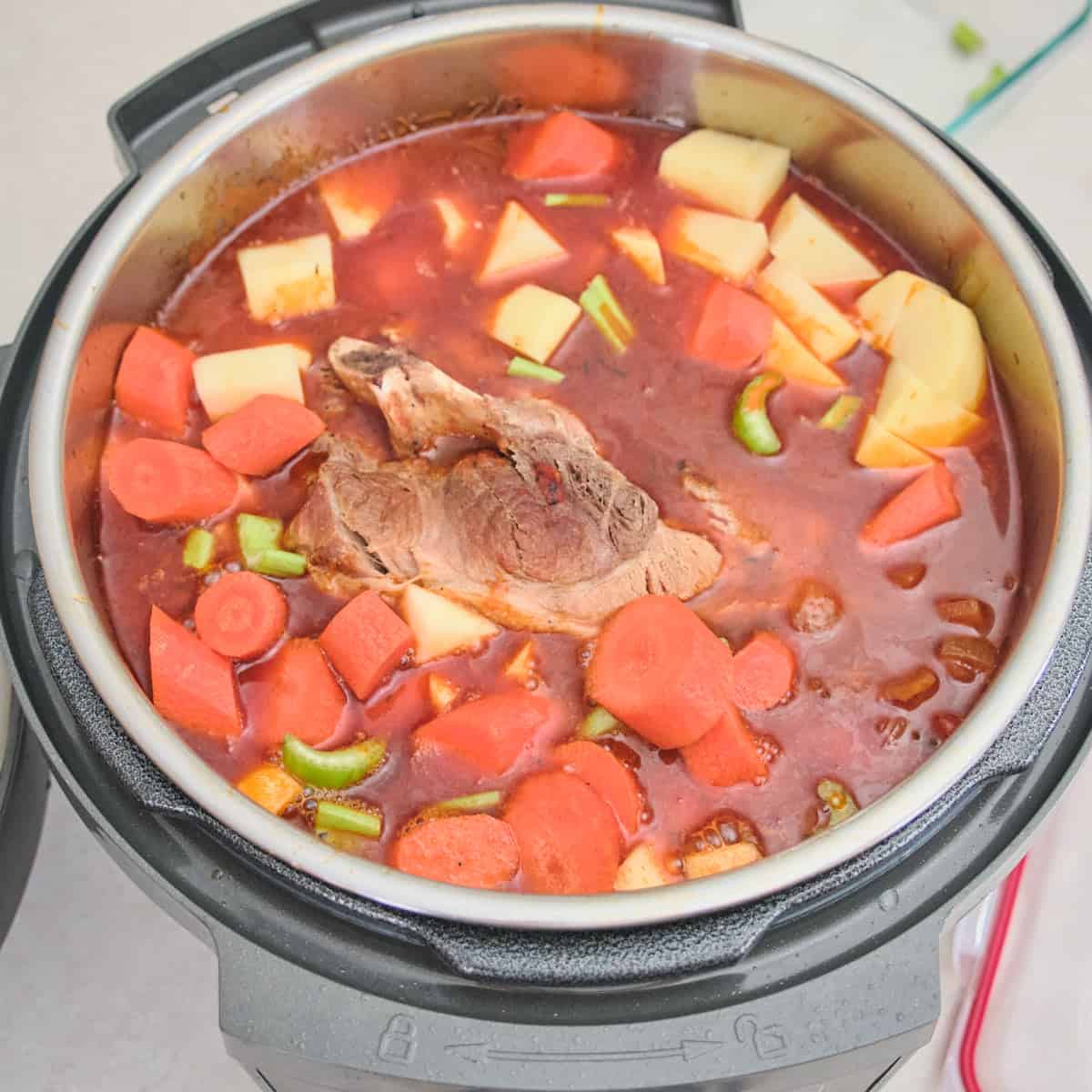 Adding carrots, potatoes, apples, and celery