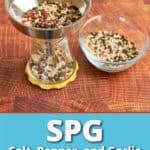 A funnel of whole spices pouring into a grinder